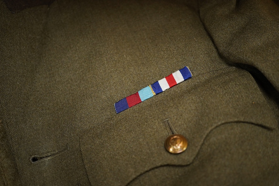 A WWII Welsh Guard’s uniform, comprising a dress jacket, two dress blouses, one with label stating 1940 Pattern Size No.6, breast 38” to 39”, waist 33” to 34”, a pair of breeches, a pair of trousers and a tie, together w